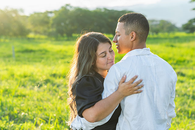 A happy married couple spending time together in a green field