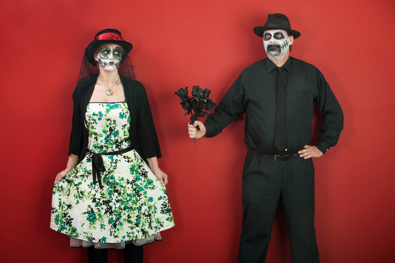A man and woman in outfits and face paint for Dia de los Muertos