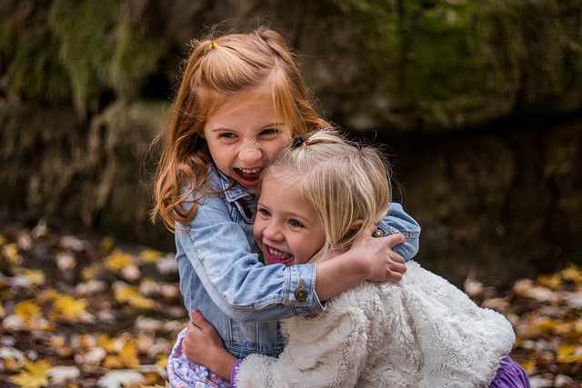 Two small children hugging each other