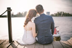 A happy couple sitting by the sea