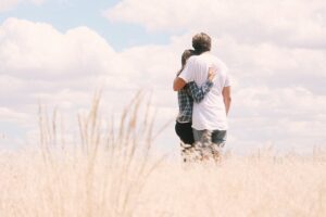A couple hugging outdoors