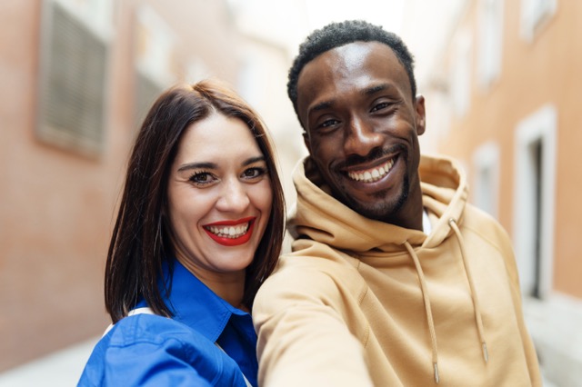 Marriage advice for cultural differences: a couple from different cultural backgrounds standing outdoors in a charming urban setting