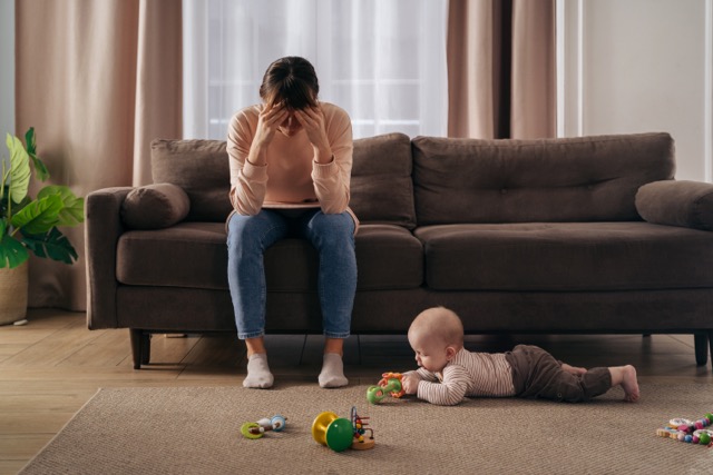 A tired mother sitting alone
