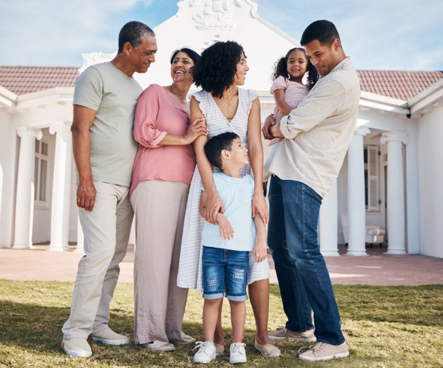 A large family outdoors together, children, parents and grandparents