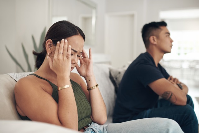 An unhappy couple sitting together