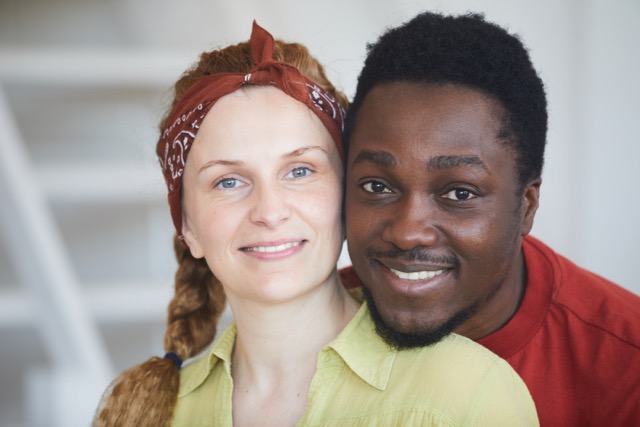 A multiracial couple embracing, comfortable with their cultural differences