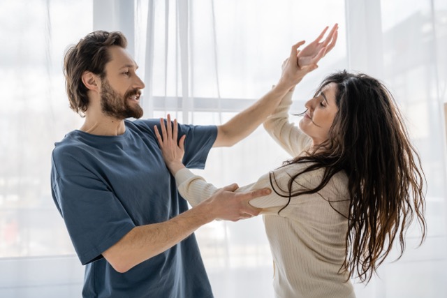 An angry man threatening a frightened woman during a conflict at home