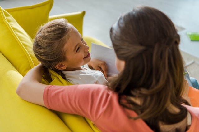 Overhead view of a happy child sitting on the sofa