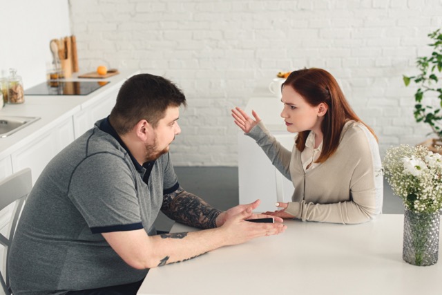 An unhappy couple quarrelling at home