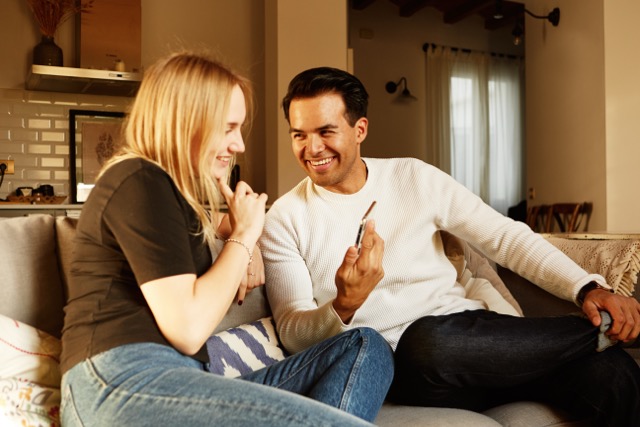 A young couple having a conversation on the sofa at home