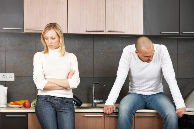A married couple quarrelling in the kitchen