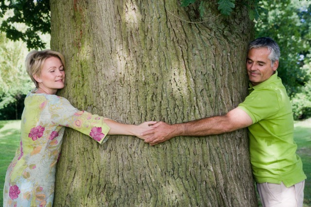 A couple hugging a tree, close up