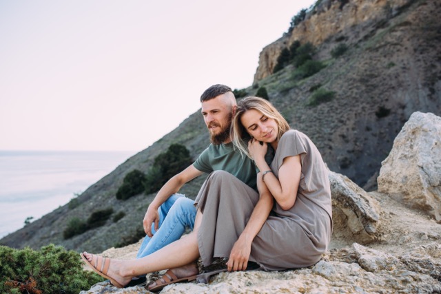 A couple walking and hugging by the sea