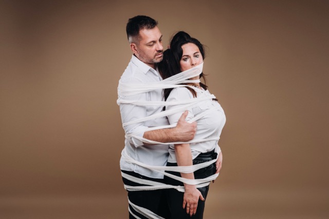 A couple entwined in a troubled embrace