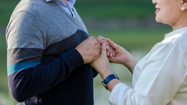 The hands of an elderly couple