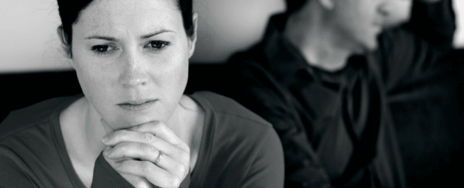 Black and white photo of distraught couple and caption How Do We Love Each Other's Darkness?