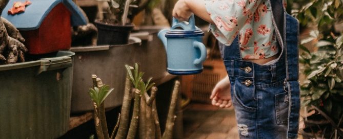 Young girl watering plants