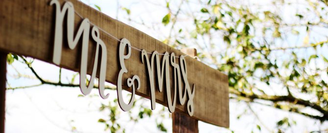 Simple outdoor wood plank with hanging Mr & Mrs script lettering