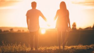 Happy couple standing in the sun