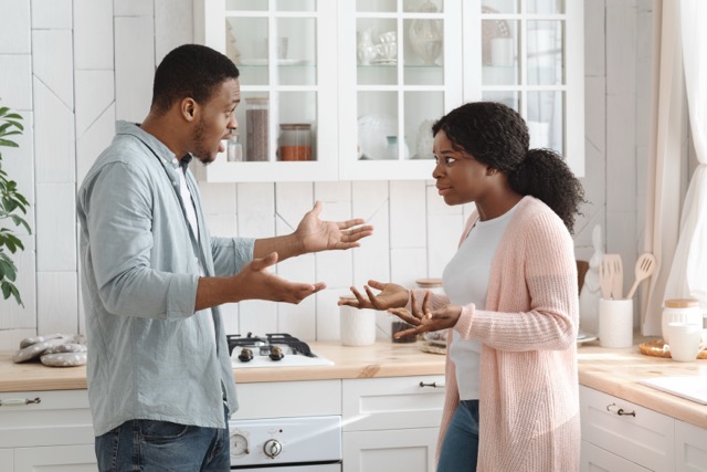 Crisis In Relationship. Portrait Of Black Man And Woman Arguing In Kitchen, Young African American Couple Quarreling At Home, Suffering Misunderstanding, Having Marital Problems, Side View, Free Space