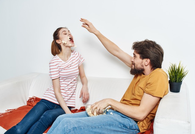 Stupid Arguments in Marriage: two married couples doing funny, stupid activities by popcorn.