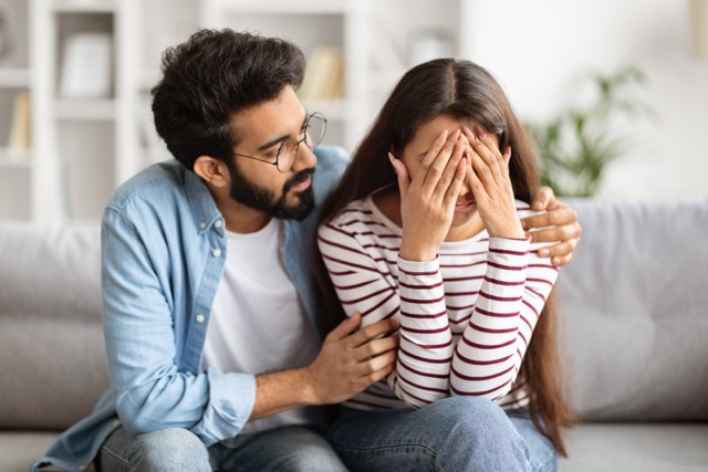 Loving husband indian man comforting consoling upset Marriage Anxiety : crying wife woman, giving psychological support care compassion, helping sharing grief or problem, miscarriage, empathy in couple relationships