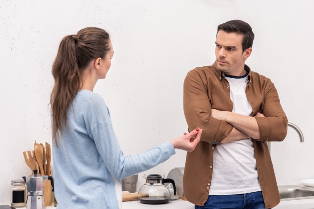 Passive aggression in marriage: mad adult couple having argument in the kitchen