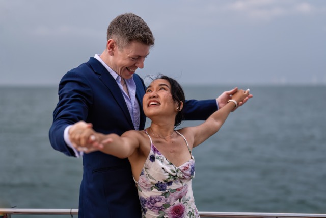 Romantic couple in love have fun sailing in the sea standing on yacht deck enjoy amazing view