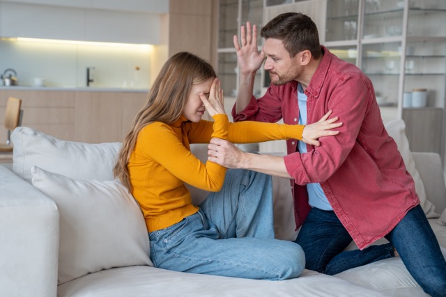 Passive aggression in marriage: Crying woman suffering from domestic aggression, violence, protecting from tyrant man ready to hit, beat. Nervous husband, tyrant, aggressor, narcissist threatening wife. Relationship difficulties