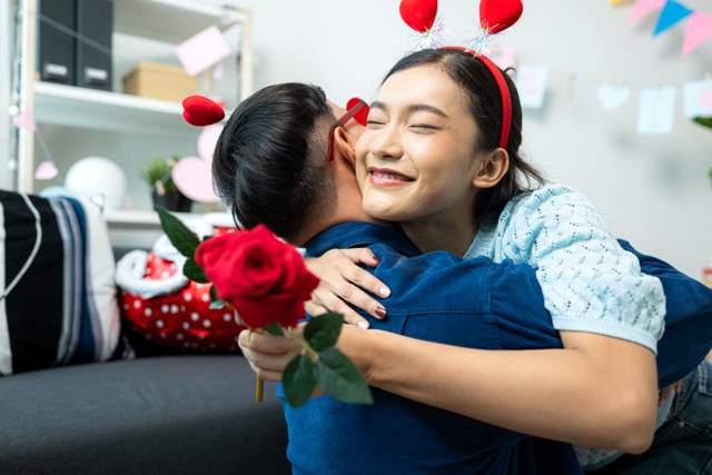 A young couple with rose Day activities at home.