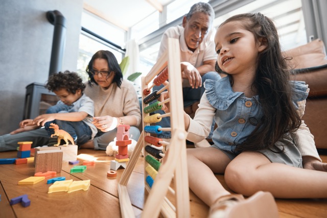 Education, toys and grandparents with children on floor for playing, educational games and learning.