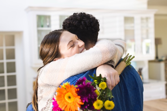 Two couple are hugging at hug day.