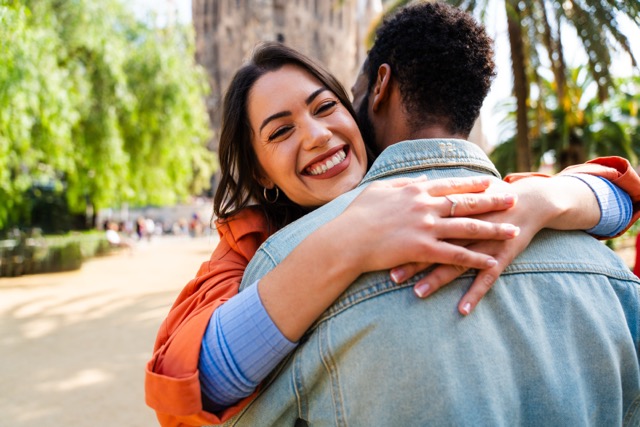 Multiracial beautiful happy marriage couple hugging each other. 