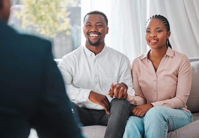 Shot of a young marriage couple meeting with their home marriage therapist.