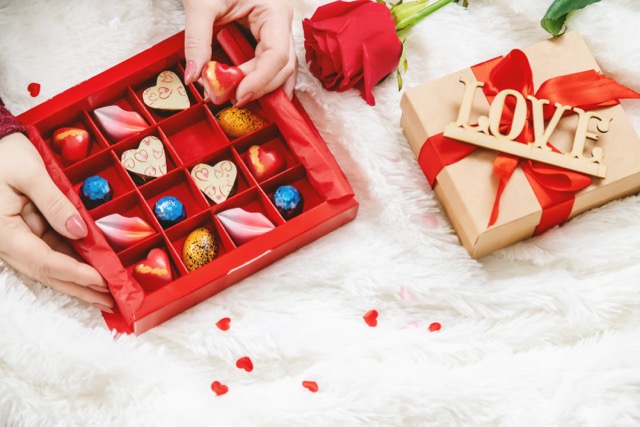 Chocolate box with red rose.