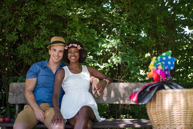 a young man and a beautiful girl enjoying a bike ride in nature on a sunny summer day.