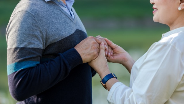 Hands elderly marriage couple while being in a great mood.